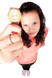 Girl holding ticking watch