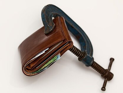 Wallet held tightly closed by a G clamp